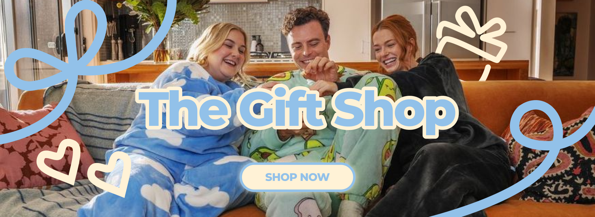 Three people sitting on a couch with decorative elements and 'The Gift Shop' text.
